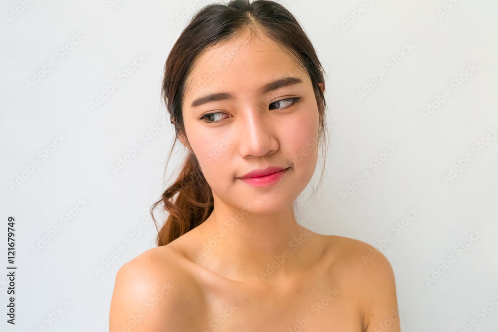 Beautiful woman with healthy clean skin presenting something on Beautiful woman with healthy clean skin presenting something on