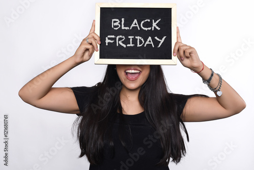 Woman holding chalkboard with text black friday.