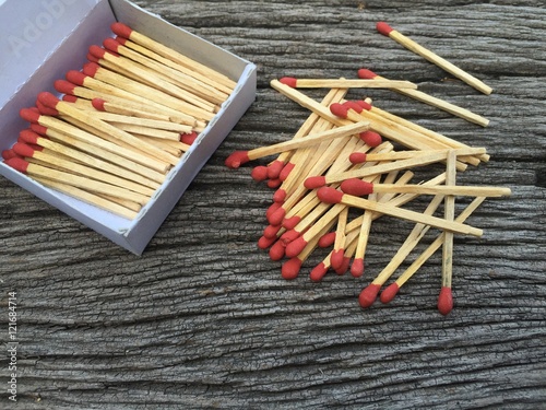 matches and matchbox on wood background