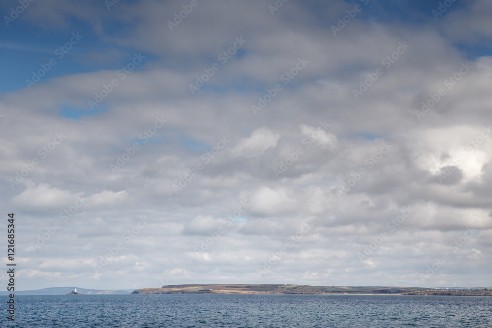 white fluffy clouds down by the sea