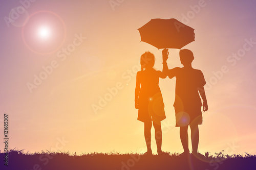Silhouette children with umbrella on sunset © sawitreelyaon