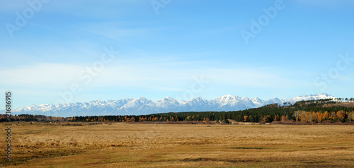 Fototapeta Naklejka Na Ścianę i Meble -  blue sky over the vast steppes, Tunka valley, mountains covered with snow, Sayan mountains. Used deep toning of the photo 