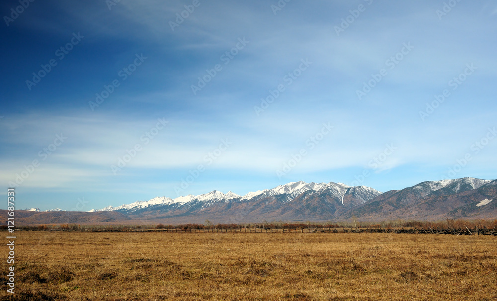 Fototapeta premium blue sky over the vast steppes, Tunka valley, mountains covered with snow, Sayan mountains. Used deep toning of the photo 