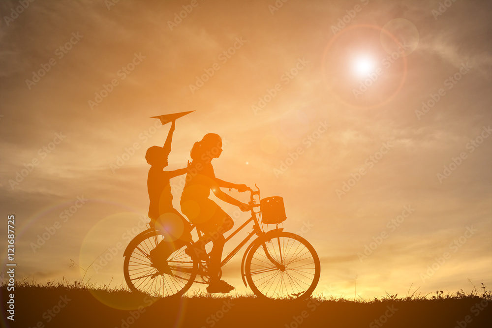 Silhouette women and boy playing on sunset Silhouette women and boy playing on sunset