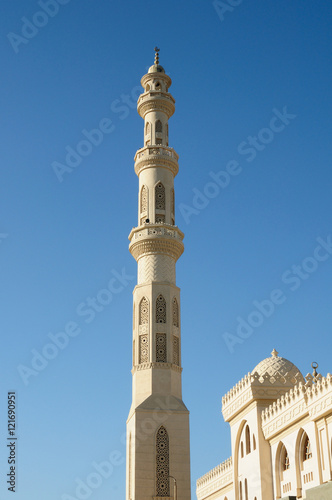 tower minaret of muslim mosque in front of azure blue sky
