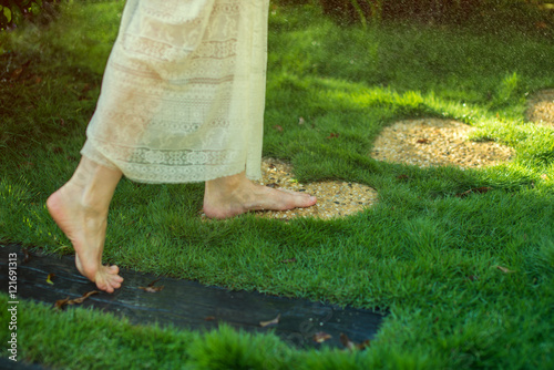 girl walking barefoot on the stones in heart shape photo