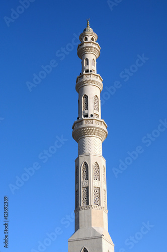 tower minaret of muslim mosque in front of azure blue sky