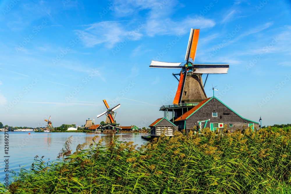 Fully operational historic Dutch Windmills along the Zaan River at the village of Zaanse Schans in the Netherlands