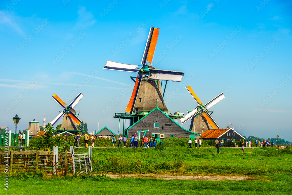 Fototapeta premium Fully operational historic Dutch Windmills along the Zaan River at the village of Zaanse Schans in the Netherlands