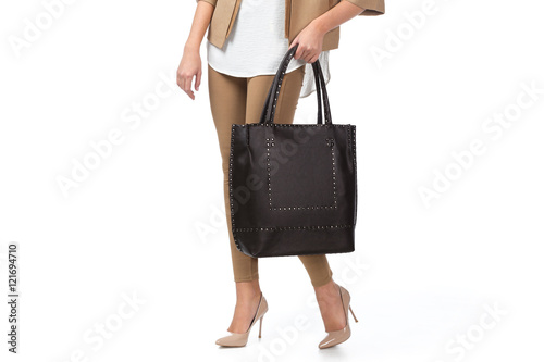Woman holding a handbag isolated on white background