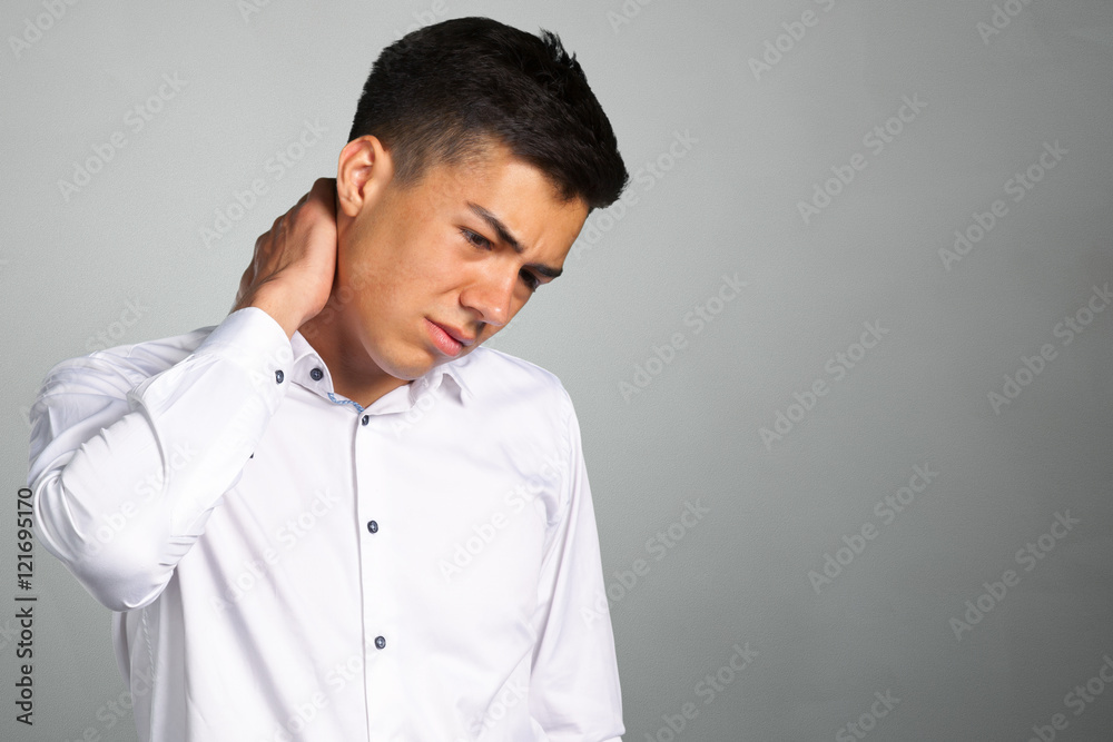 Fototapeta premium Frustrated young man in shirt massaging his neck
