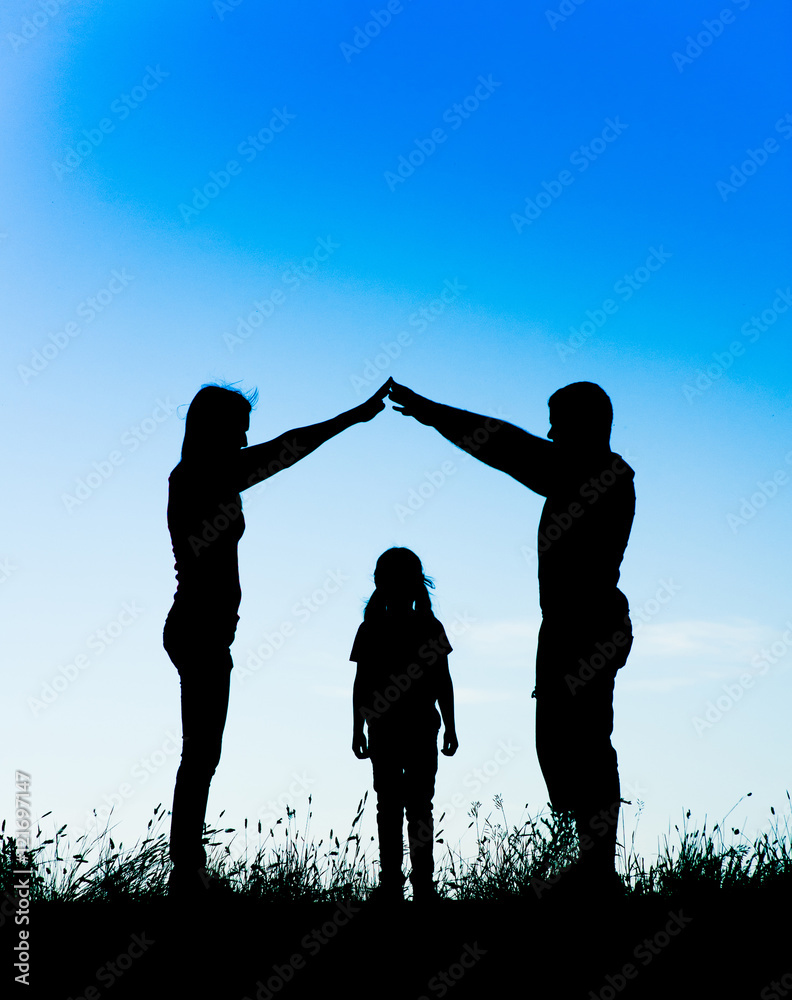 Silhouette of a happy family making the home sign