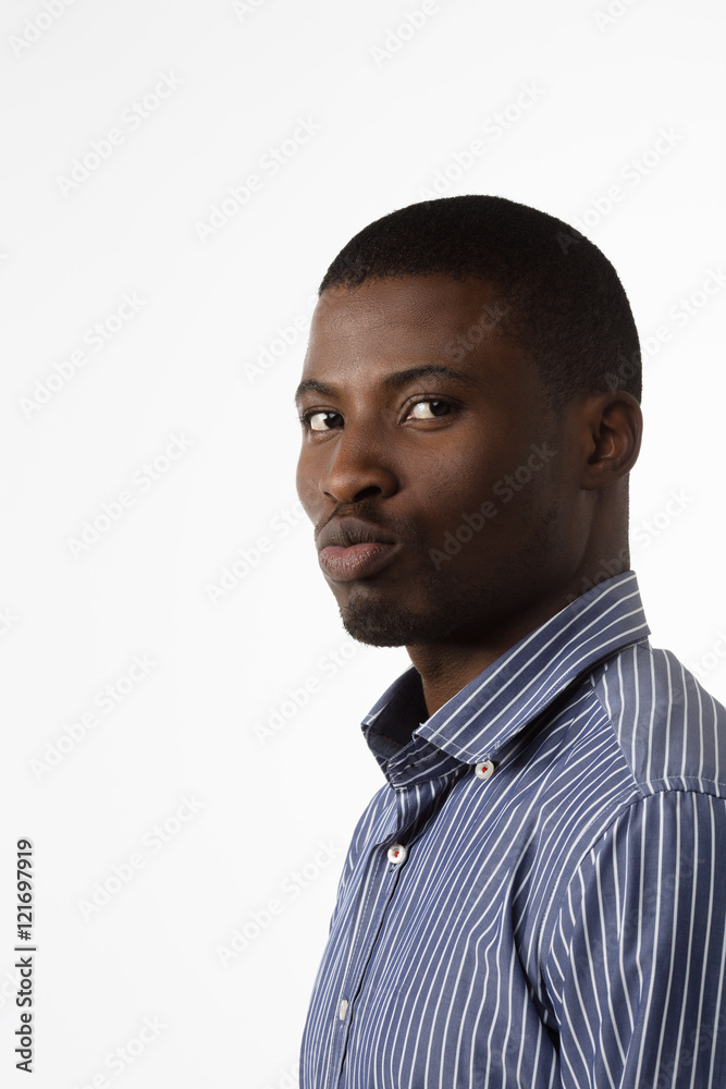 Obraz premium Portrait of Afro-American businessman looking at camera in studio. Handsome man in blue shirt posing for photographer isolated on white background.
