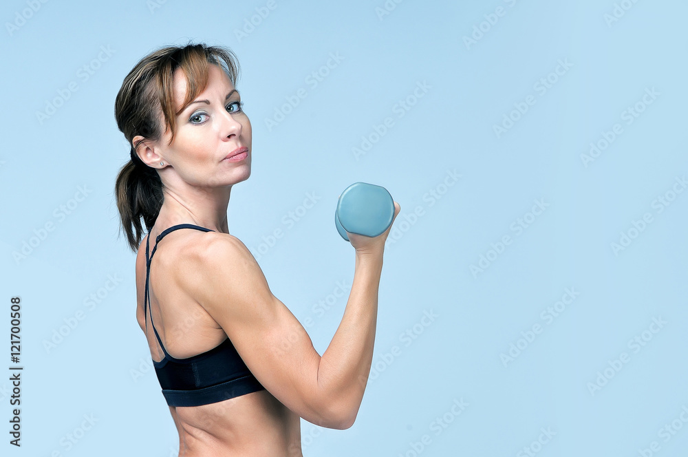 Fototapeta premium Sport fitness woman doing exercise with dumbbells