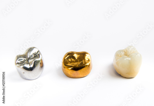 Dental ceramic, gold and metal tooth crowns on white background. Isolated.