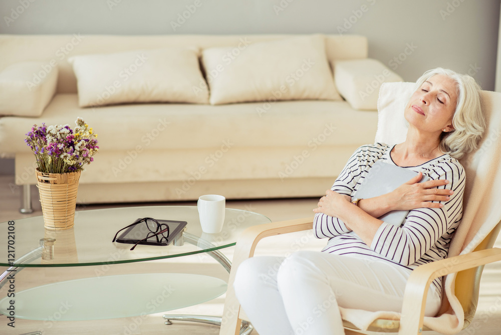 Pleasant delighted senior woman resting at home Pleasant delighted senior woman resting at home