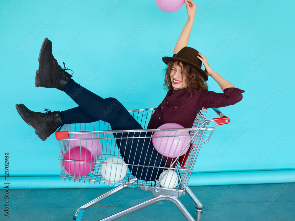© kegfire - Beautiful brunette girl sitting in shopping cart © kegfire - Beautiful brunette girl sitting in shopping cart