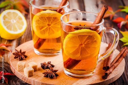 hot tea with lemon, anise and cinnamon in glass mugs