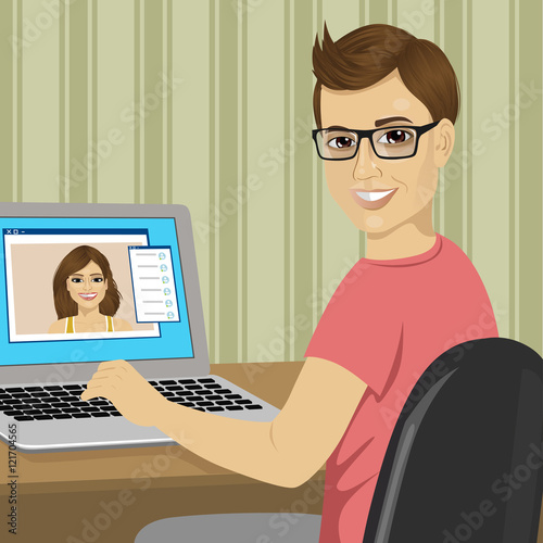 young nerd boy chatting with his girlfriend with video call using laptop sending text messages