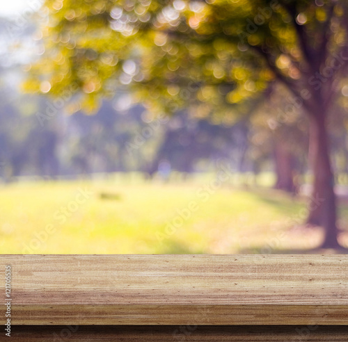 Empty wooden table over blurred tree with bokeh background