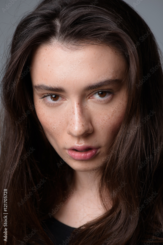 attractive girl face on light grey background attractive girl face on light grey background