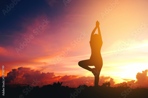 Silhouette young woman practicing yoga