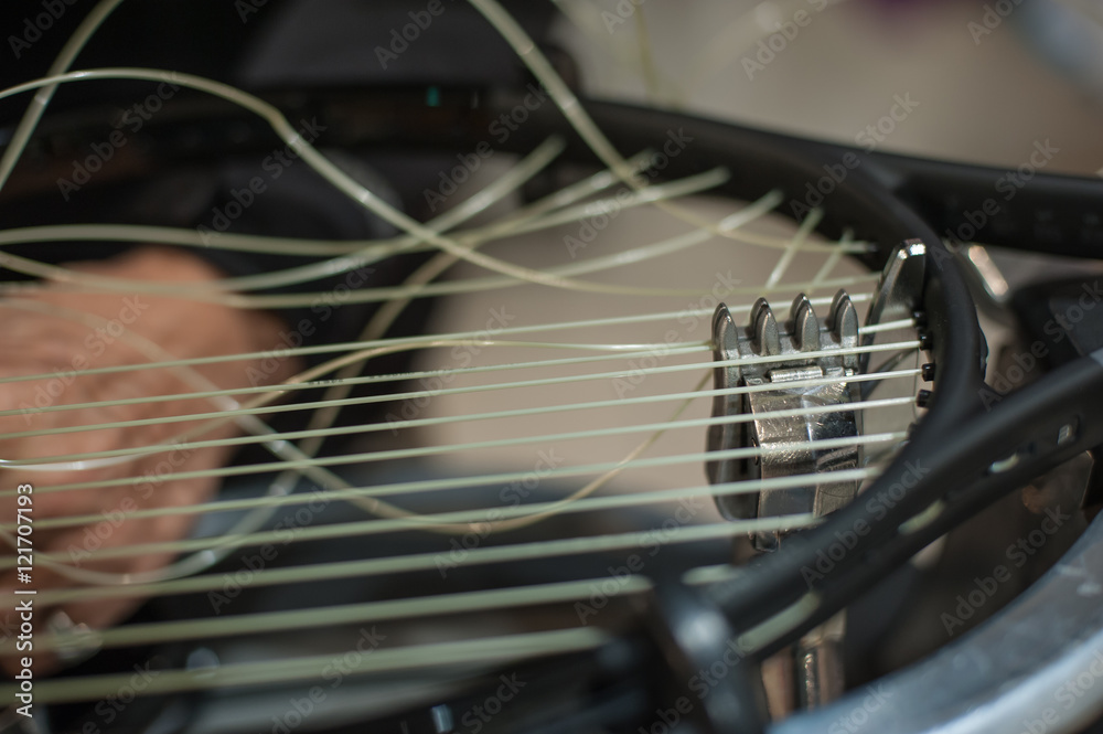 Fototapeta premium Racket stringing. Detail of tennis racket in the stringing machine