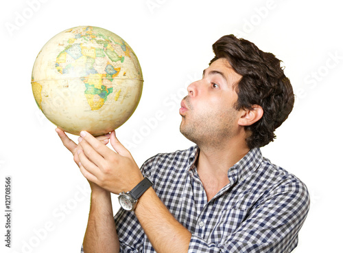Young man isolated showing a globe