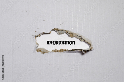 The word information appearing behind torn paper photo