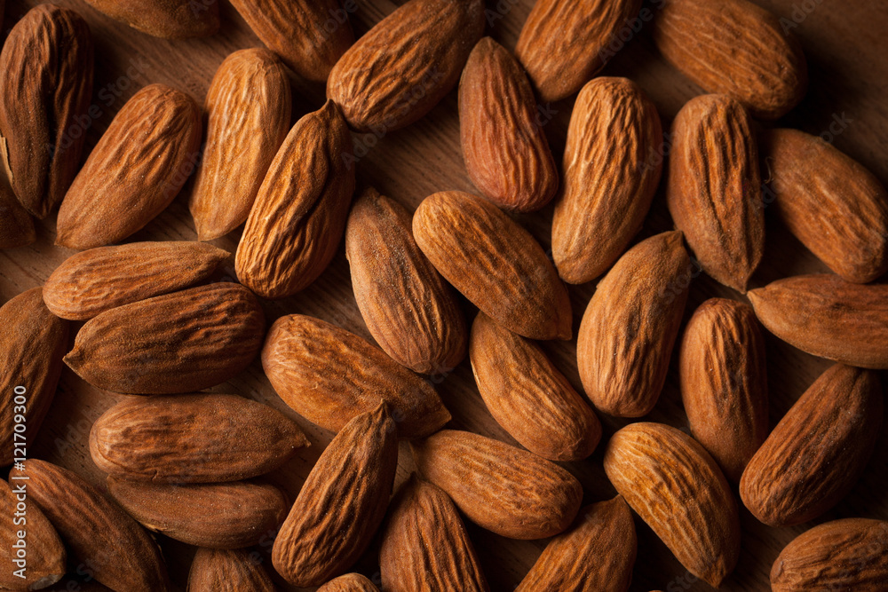 Fototapeta premium Almonds on wooden background