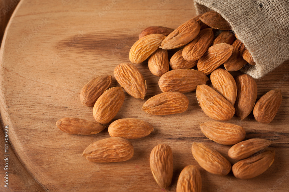 Almonds on wooden background