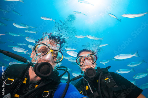 Scuba divers looking at camera underwater © Jag_cz