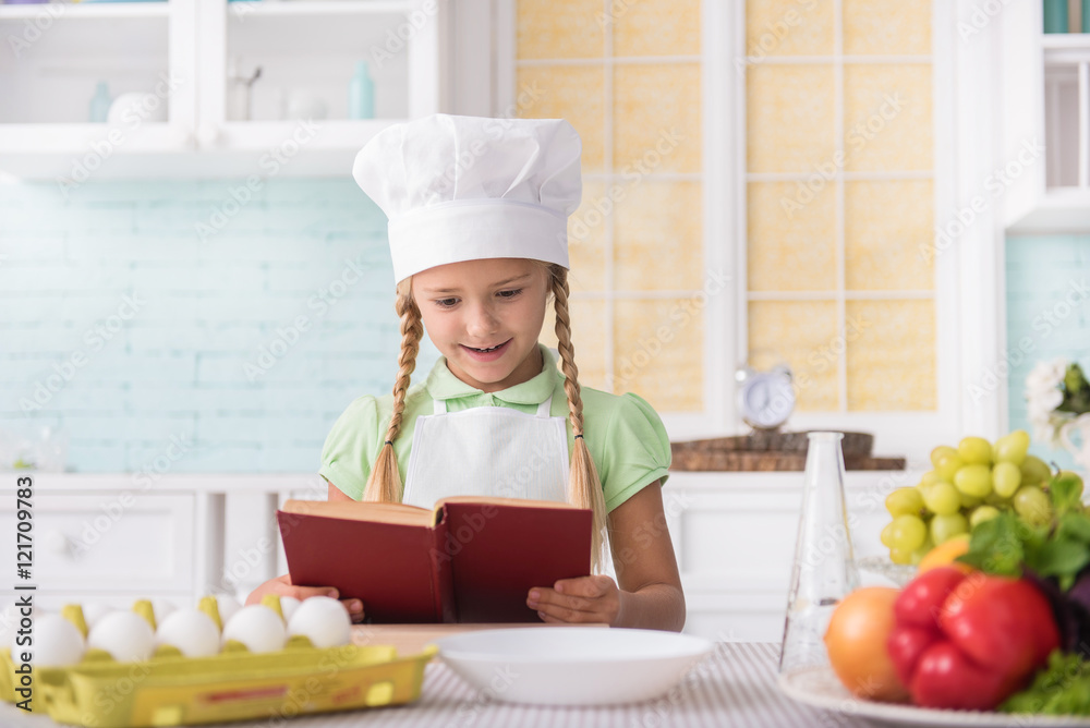 Joyful child is ready to cook Joyful child is ready to cook