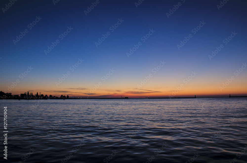 SUNRISE OVER THE SEA. Sunny dawn in the port of Gdynia