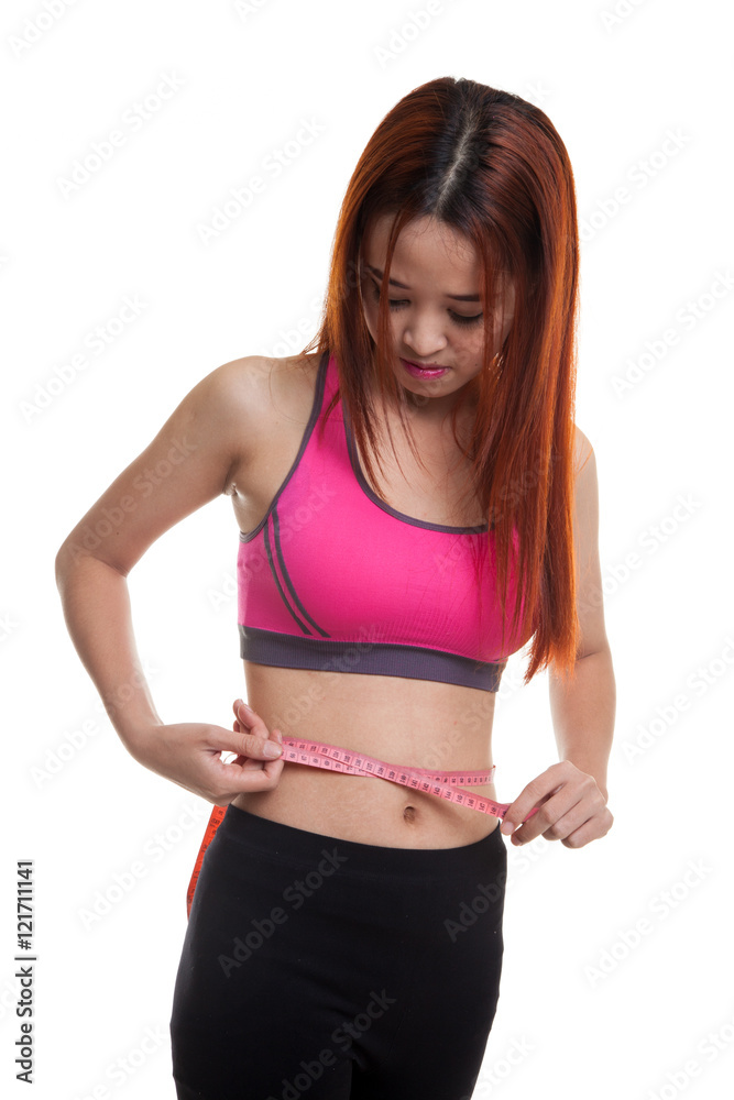 Beautiful Asian healthy girl measuring her waist. Beautiful Asian healthy girl measuring her waist.