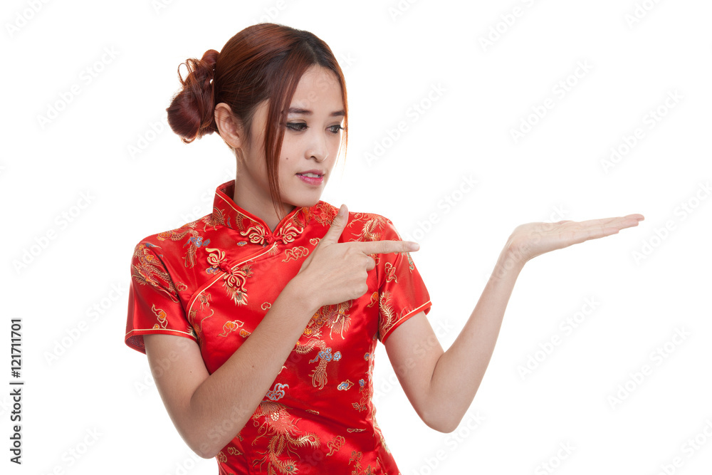 Asian girl in chinese cheongsam dress point to blank space on h Asian girl in chinese cheongsam dress point to blank space on h