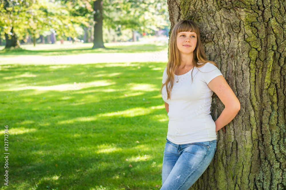 Closeup portrait of young woman near tree