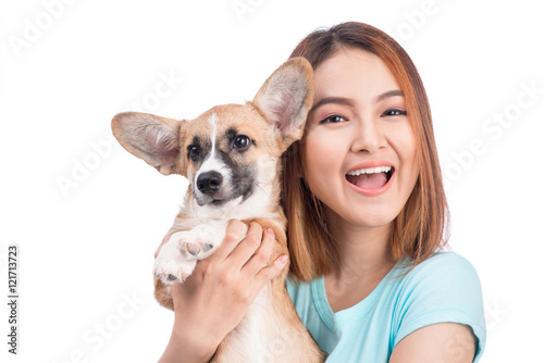 Young asian woman with a little puppy isolated over a white back