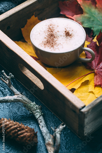 spiced latte or coffee in a glass on a vintage table. Autumn or winter hot drink.