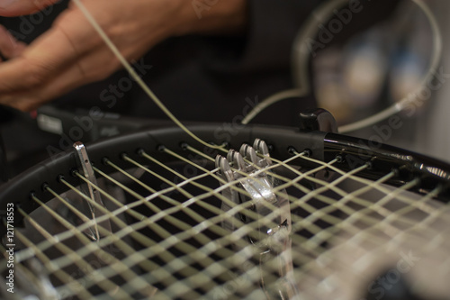 Racket stringing. Detail of tennis racket in the stringing machine photo