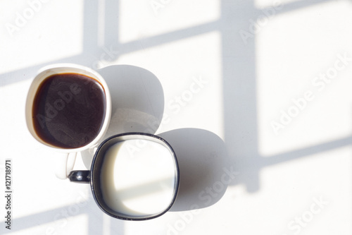 black and white cup of milk  coffee on natural background  top view