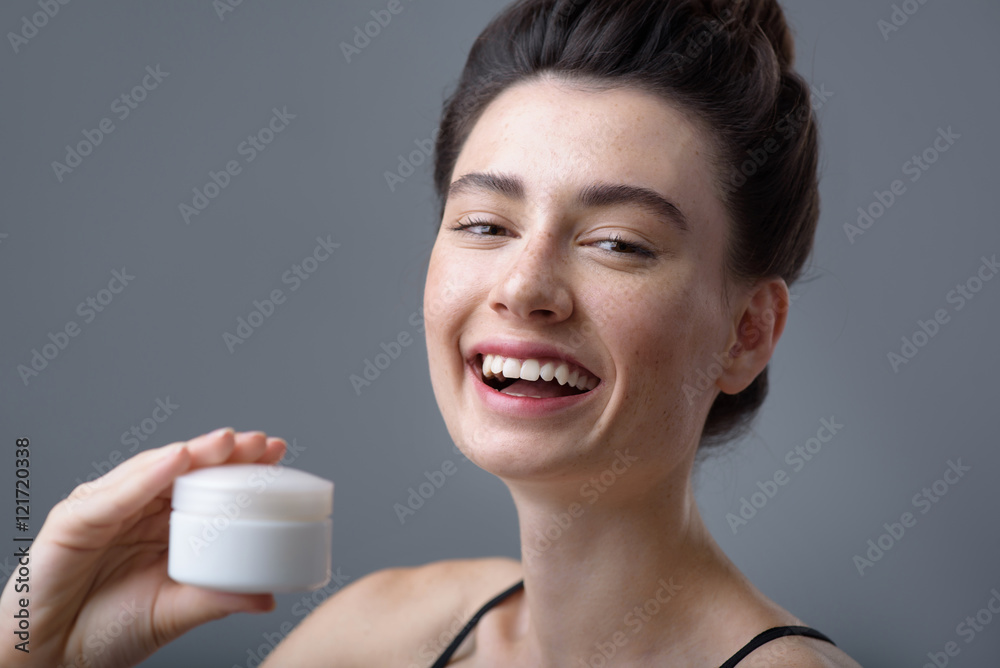 young smiling woman on grey background with copy space young smiling woman on grey background with copy space
