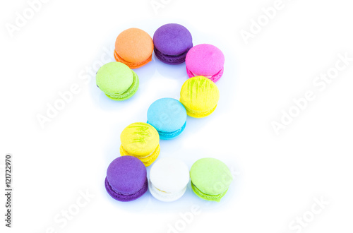 Colorful macarons number 2 on white background