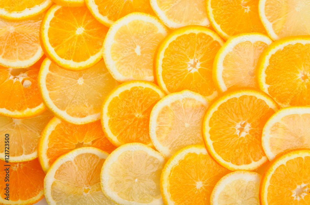 citrus background. juicy slices of lemon and orange cover the entire surface. citrus background. juicy slices of lemon and orange cover the entire surface.