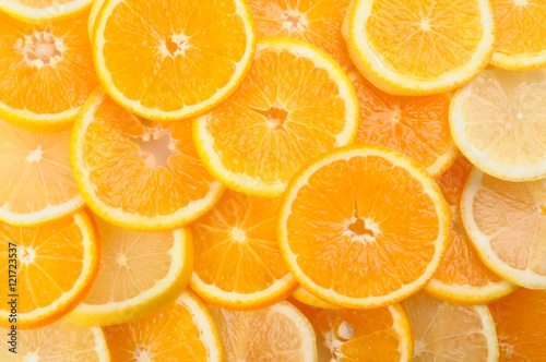 citrus background. juicy slices of lemon and orange cover the entire surface. 