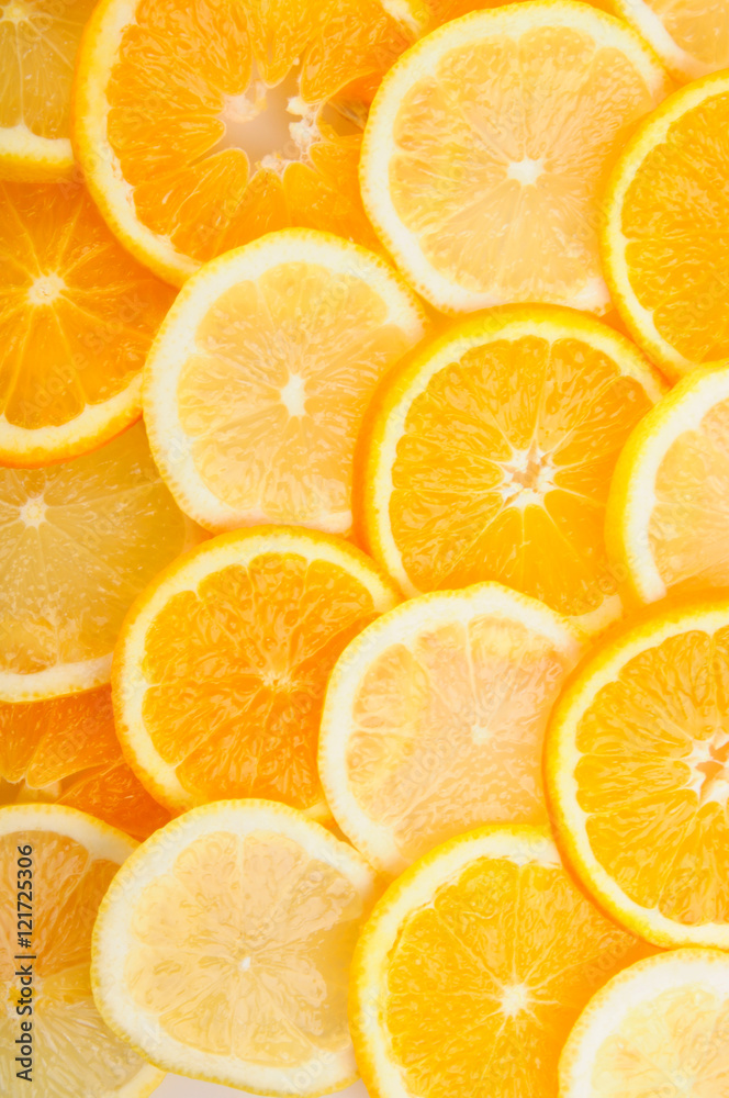 citrus background. juicy slices of lemon and orange cover the entire surface. citrus background. juicy slices of lemon and orange cover the entire surface.