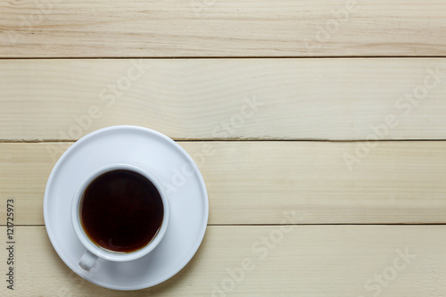 Top view black coffee on wood table.