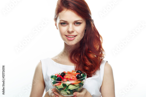 Beautiful woman eating a salad. Isolated background 