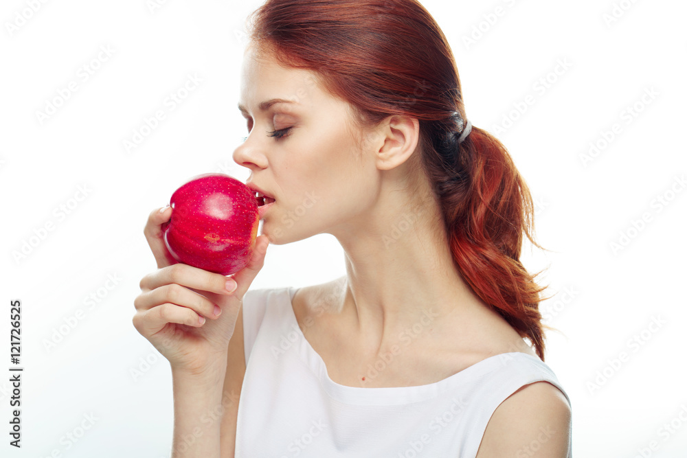 Beautiful young woman eating an apple
Beautiful young woman eating an apple