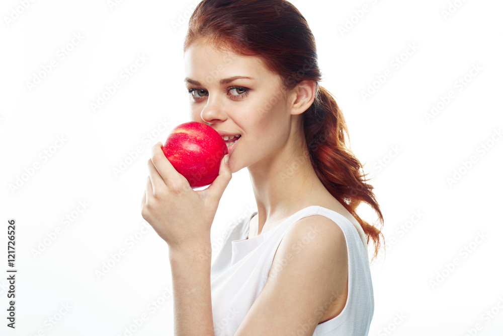 Beautiful young woman eating an apple
Beautiful young woman eating an apple